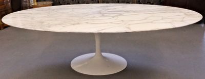 a white table with a marble top in a living room