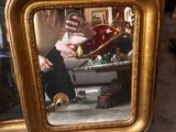 a mirror with a picture of a man taking a picture of himself