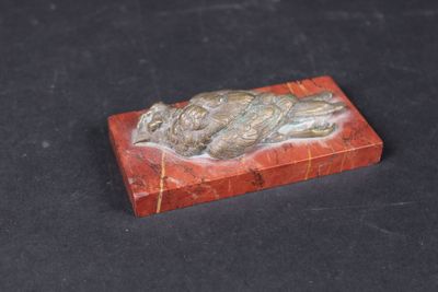 a close up of a red marble box on a black surface