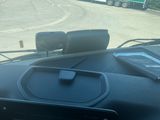 a cell phone sitting on the dashboard of a car