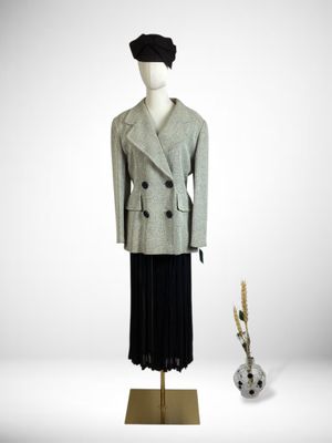 an image of a mannequin dressed in a gray coat and black skirt