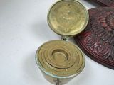 a small brass object sitting on a table next to other items