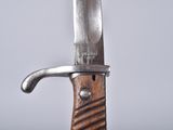 a close up of a knife with a wooden handle