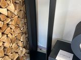 a stack of firewood next to a black table