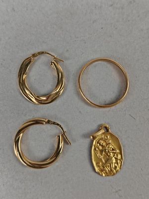 three pairs of gold hoop earrings and a gold coin