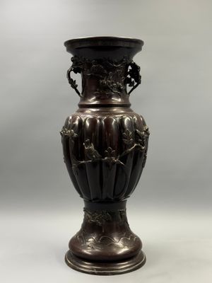 a bronze vase that is sitting on a table