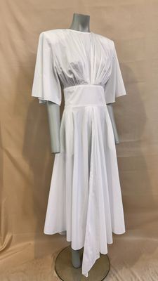 the mannequin is wearing a white dress on a mannequin stand