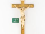 wooden crucifix on a white background with a green sign