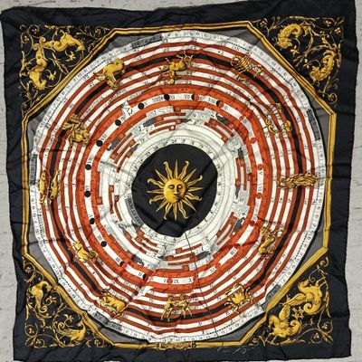 an image of a square scarf with a sun in the center
