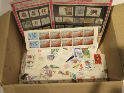 a box full of stamps and postcards sitting on a table