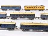 a lot of toy trains that are lined up on a table