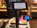 an image of a cash register with a cell phone on top of it