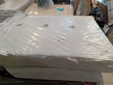 a lot of mattresses sitting on top of each other in a room