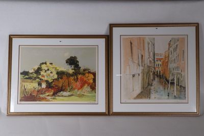 two paintings hanging on the wall above a bed