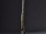 an old knife on a wooden stand against a black background