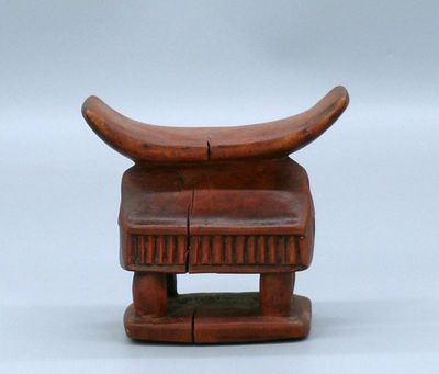 an image of a small wooden chair with a curved seat