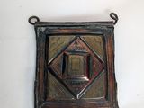 an image of a metal plaque with a square design on it