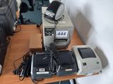 a desk with a printer, printer, and other electronic equipment on it