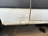 a white van with a sticker on it parked in a garage