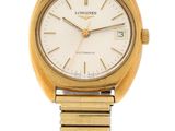 a close up of a gold wrist watch with a white dial