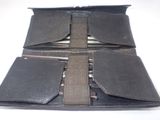 a black leather wallet with a pen and pencils in it