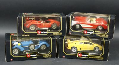four toy cars are in a box on a black surface