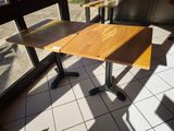 a table and chairs in a restaurant with a view of the outside