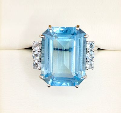 an image of a blue topaz ring with diamonds