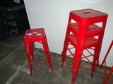 three red stools sitting next to each other in a room