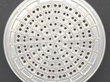 an overhead view of a metal strainer on a black surface