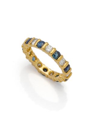 une bague en or jaune sertie de diamants bleus et blancs