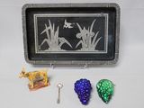 a silver tray with a picture of birds and grapes on it