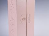 pink cardboard box with a logo on the front and side of it