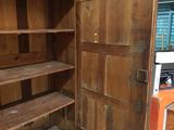 a large wooden cabinet with shelves and shelves in the room