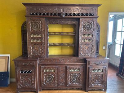 a large wooden cabinet with a mirror on top of it