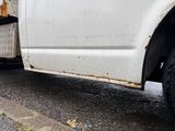 a white truck that is parked on the side of the road