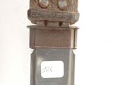 a metal object with a number on it on a white surface