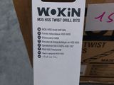 a box of wokin ' s on the floor next to a glass of wine