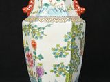 a white vase with a floral design on it