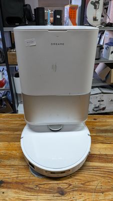 a white coffee maker sitting on top of a wooden table
