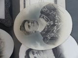 two plates with pictures of women on them on a table