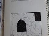 an open book with a drawing of a man in a cave