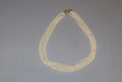 three strand pearl necklace with a gold clasp and clasp