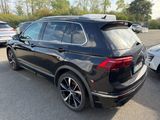 the rear end of a black volkswagen suv parked in a parking lot
