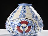 a blue and white vase sitting on a white table