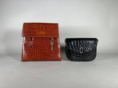 two brown and black purses sitting next to each other
