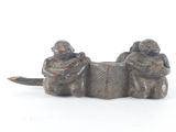 two figurines of monkeys sitting next to each other