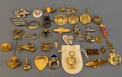 de nombreuses broches en or et en argent posées sur une table