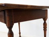 a small table with a wooden top on a white floor