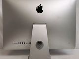 an apple computer sitting on top of a white table